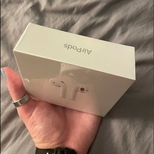 brand new apple airpods. plastic wrapping on still
